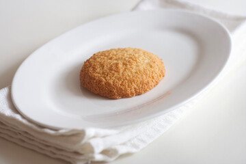 Coconut cookies in a plate on a white table