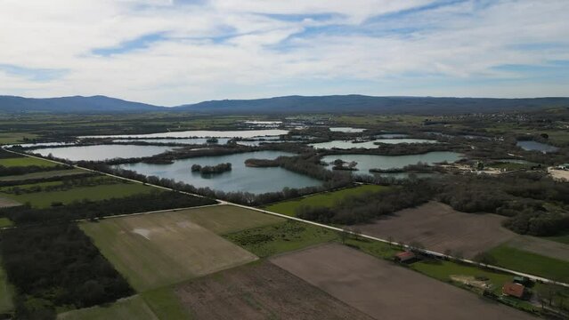 Panoramic aerial dolly above farmland plot fields and ancient Antela lagoon Areeiras da Limia in Xinzo de Limia Ourense Galicia Spain