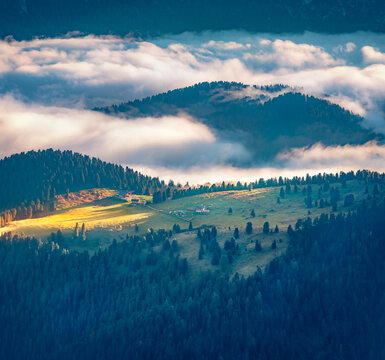 Foggy summer view of Naturerlebnisweg Zans hiking area. Fantastic morning scene of highland farm in Dolomite Alps, Italy, Europe. Beauty of countryside concept background..