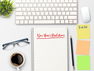 2024 New Year's Resolutions text in a notebook on a wooden desk.strategy, solution, goal, business, New Year goals