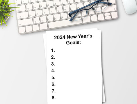 2024 New Year's goals text in a notebook on a wooden desk.strategy, solution, goal, business