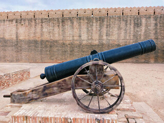 Old cannon gun ancient war weapon in a fort  canhao toap top-gun cannone antique-cannon iron-cannon wheel-cannon kanone artillery barrel army firearm in a castle photo 