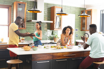 Diverse group enjoys a lively moment in a modern kitchen