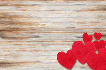 Red paper heart on wooden table background.