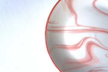 a plate with pink streaks on a white background. isolated. a place for the text.