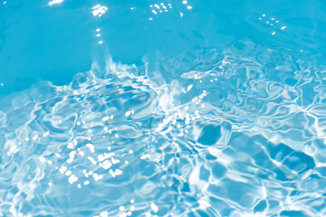 Blue water surface texture with ripples, splashes, and bubbles. Abstract summer banner background...