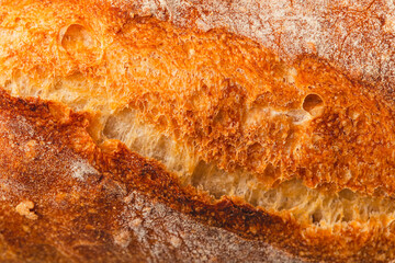 Ruddy crust of bread as an abstract background. Texture