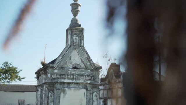 An old grave within Lafayette Cemetery #2 in New Orleans, Louisiana on a sunny, cold winter day. 
