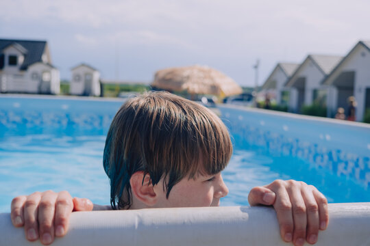 Boy happy swimming in a pool