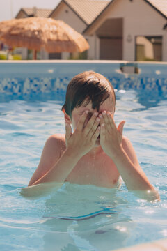 Boy happy swimming in a pool