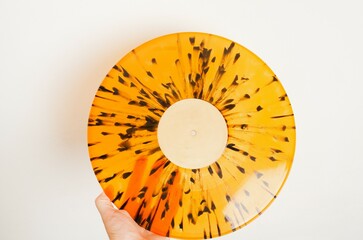 Vinyl disc lying down held in hand. Vintage