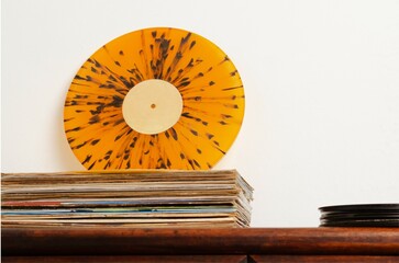 Vinyl records lying on wall on table. Retro