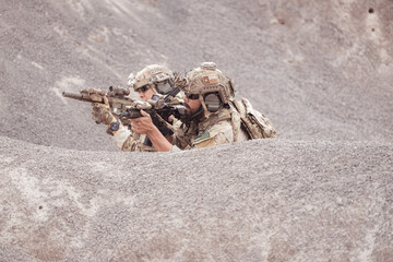 Soldiers in camouflage military uniforms carrying weapons, Reconnaissance missions in rugged mountains, Assault infantry battle training.