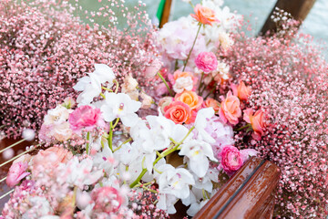 Pink, orange, white blooms on water taxis in Venice Italy