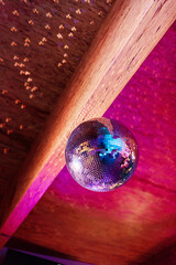 colourful playful disco ball hanging above wedding dance floor