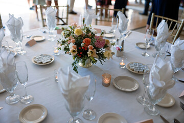 Refined white table with lush floral arrangement