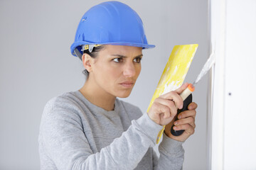 female builder working with a trowel and float