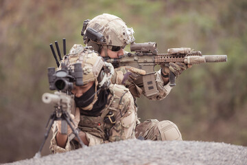 Soldiers in camouflage military uniforms carrying weapons, Reconnaissance missions in rugged mountains, Assault infantry battle training.