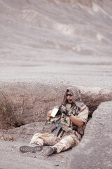 Soldiers in camouflage military uniforms carrying weapons, Reconnaissance missions in rugged...