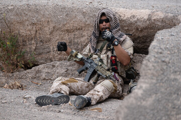 Soldiers in camouflage military uniforms carrying weapons, Reconnaissance missions in rugged...