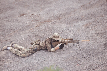 Soldiers in camouflage military uniforms carrying weapons, Reconnaissance missions in rugged...