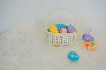 easter holiday concept with colorful egg and put in basket with tree and white background