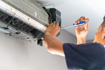 Repairman fix air conditioning systems, Technicians man using screwdrivers service for repair and...