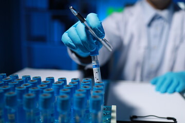 A researcher is taking notes. It is being developed in the lab as a profile for other researchers, A biological chemical scientist is writing a report on his day's work for a boss.