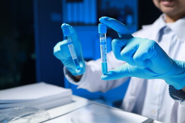 A researcher is testing a new chemical in a test tube that has just been discovered by a famous scientist, A chemist sits in a well-equipped laboratory and seriously examines test tubes.