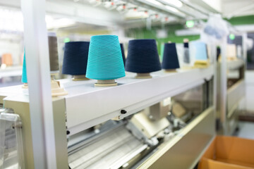 in the weaving factory There is a sewing machine and several spools of thread placed above, ready...