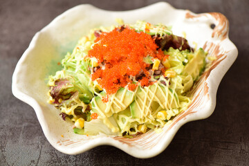 Delicious crab, tuna, fruit and vegetable salad on a plate