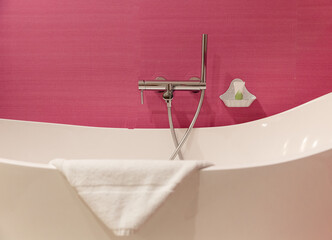 bathroom tub against pink wall - 756232066