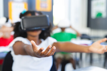A student is experiencing virtual reality in a classroom setting in school