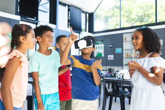 Biracial children are exploring virtual reality in a classroom setting in school