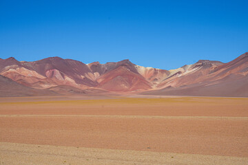 Multicoloured Desert Mountain Range, Blue Sky Background and Orange Sands  - Salar de Uyuni, Bolivia  