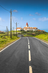 Fototapeta na wymiar The road to Cabo da Roca lighthouse. Travel to this amazing landscape landmark from Portugal at Atlantic Ocean shore.