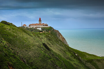 Cabo da Roca lighthouse on the cliffs from Atlantic Ocean, the most western point of Europe. Travel...