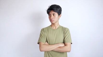 Handsome Asian man looking to the right side with crossed arms