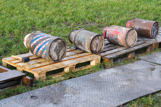 Old milk cans lying in a row. Carbide shooting is a tradition in the Netherlands and usually takes place on New Year's Eve. The goal is to make a loud bang after the carbide gas is ignited	