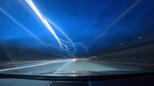 Bright motion timelapse of a speedy drive in night big city, view from car to the road and glittering streets (buildings) with colorful light trails.