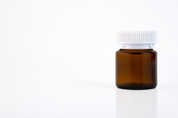 brown medical bottle with a white cap on a white background. Copy space.