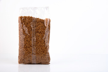 Buckwheat, groats in a plastic bag isolated on a white background. Copy space.