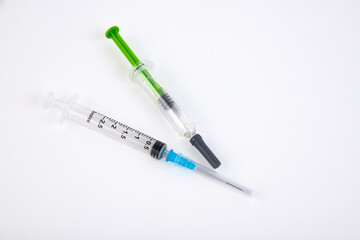 Two medical syringes on a white background. Copy space.