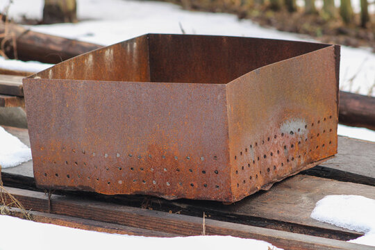 The rusty brazier warped from the heat.