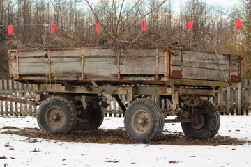 An old trailer loaded with branches from trimmed trees