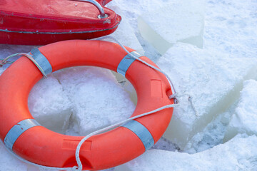 Lifebuoy on the ice of a frozen river