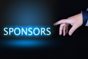 SPONSORS text, word written in neon letters on a black background pointed to by a hand with a...