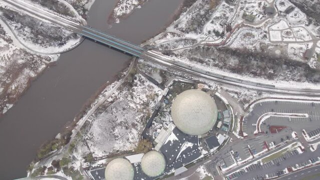 Train On Railway Passing By Randers Tropical Zoo During Winter In Denmark. aerial topdown, rotating shot