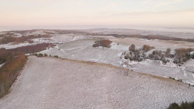 Aerial Shot Of a Scandinavian Island Countryside Covered By the Snow at Sunset