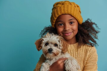 portrait of a black afro american girl holding a little dog in her arms